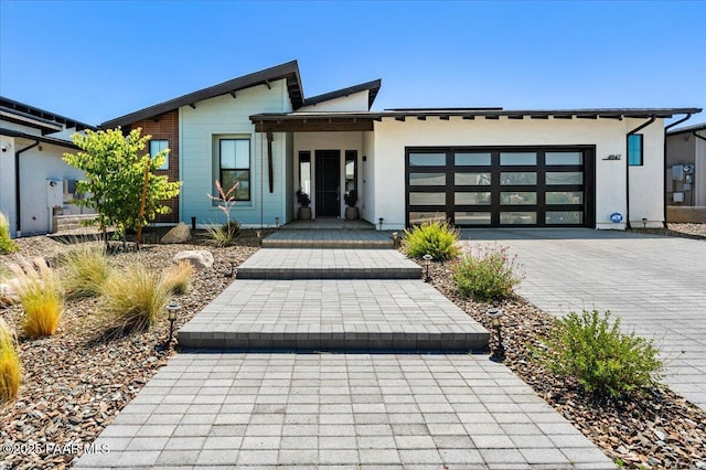 4947 Mclaury Dr, Prescott Valley, AZ 86314 - view of front of house with a garage, decorative driveway, and stucco siding