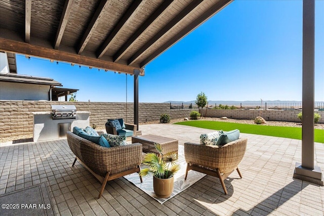 4947 Mclaury Dr, Prescott Valley, AZ 86314 - fenced backyard with an outdoor kitchen, a patio, and a mountain view