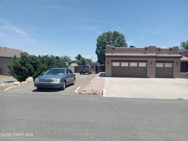 3575 N Meadowlark Dr, Prescott Valley, AZ 86314 - adobe home with a tiled roof, a garage, concrete driveway, and stucco siding