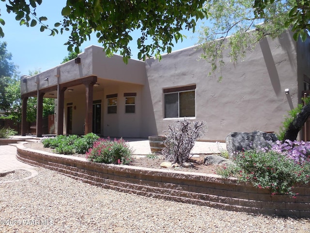 3575 N Meadowlark Dr, Prescott Valley, AZ 86314 - view of side of property featuring a ceiling fan, a patio area, and stucco siding