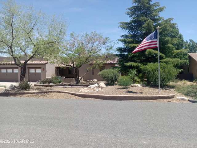 3575 N Meadowlark Dr, Prescott Valley, AZ 86314 - view of front facade featuring a garage, concrete driveway, and stucco siding
