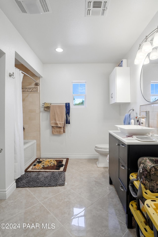 full bathroom with vanity, toilet, plenty of natural light, and shower / bath combo with shower curtain