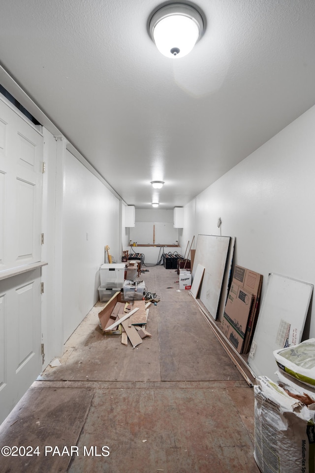 basement featuring a textured ceiling