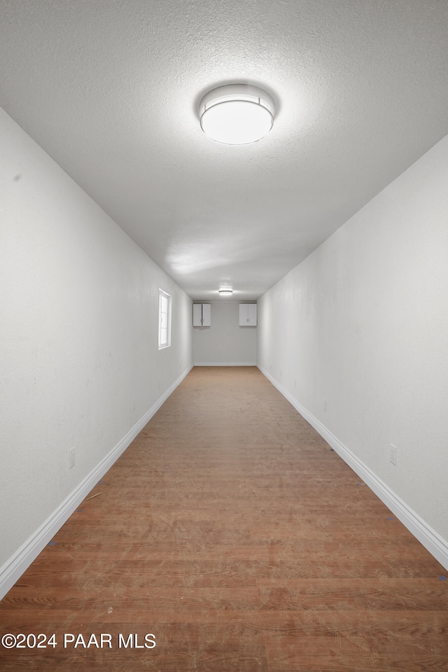 interior space featuring hardwood / wood-style flooring and a textured ceiling