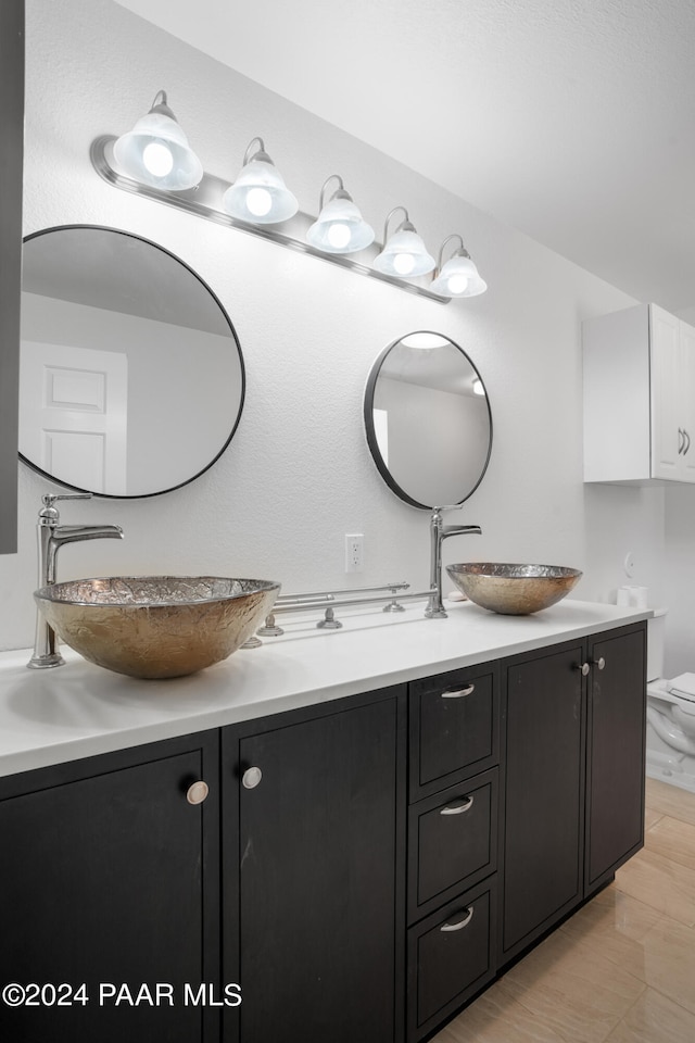 bathroom with hardwood / wood-style floors, vanity, and toilet