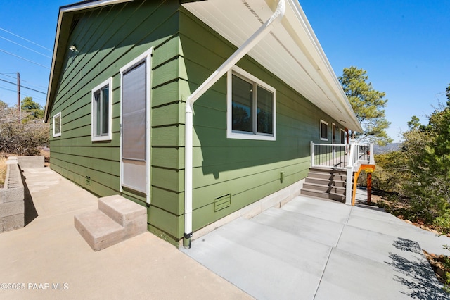 view of side of property featuring a patio area