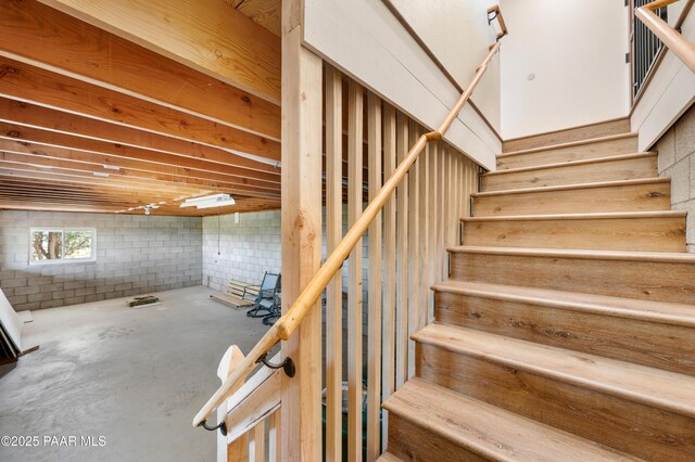 stairway featuring concrete floors