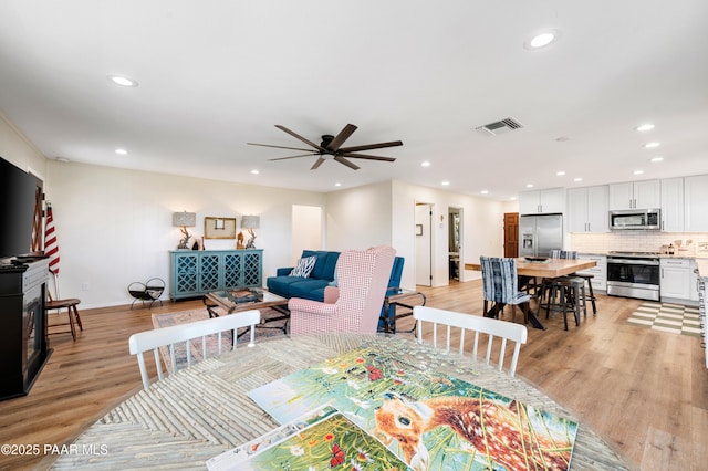 dining room with recessed lighting, visible vents, and light wood finished floors