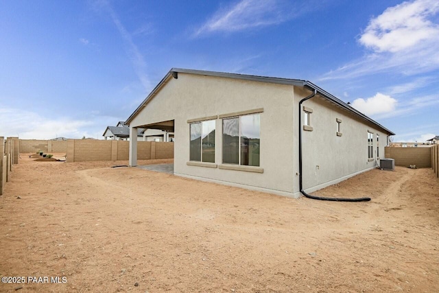 3263 Iron King Cir, Prescott, AZ 86301 - back of property featuring stucco siding, a fenced backyard, and central AC