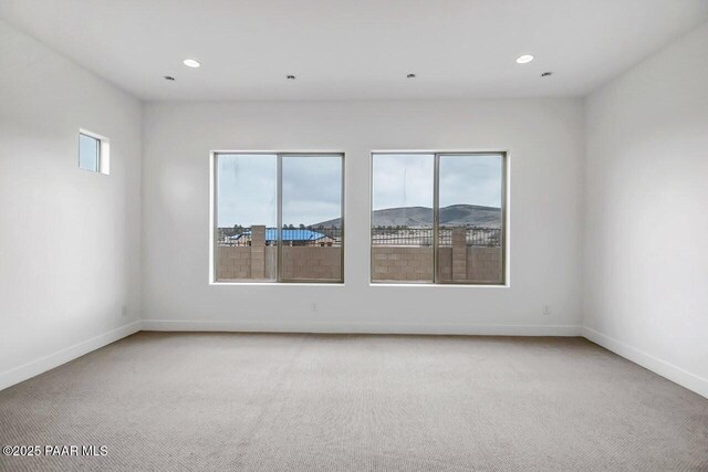 3263 Iron King Cir, Prescott, AZ 86301 - spare room featuring light carpet, baseboards, and recessed lighting