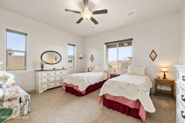 bedroom with baseboards, carpet flooring, visible vents, and a ceiling fan