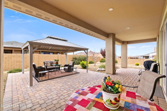 view of patio / terrace with a fenced backyard, a gazebo, and an outdoor living space