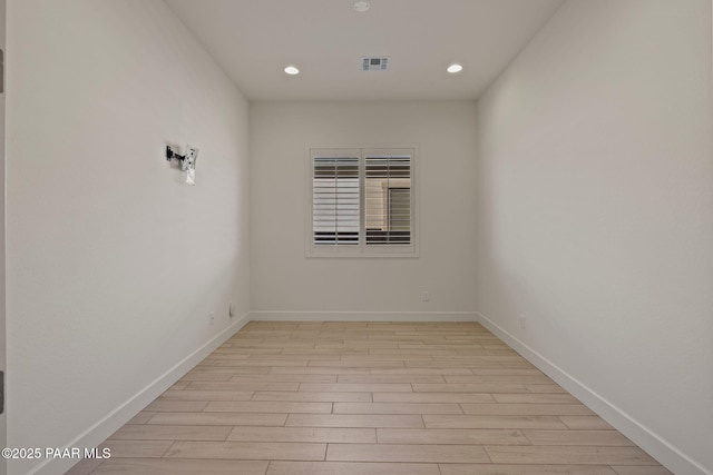 spare room featuring recessed lighting, baseboards, visible vents, and light wood finished floors