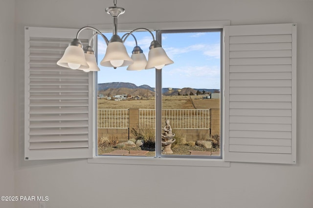 interior details featuring a mountain view and a chandelier