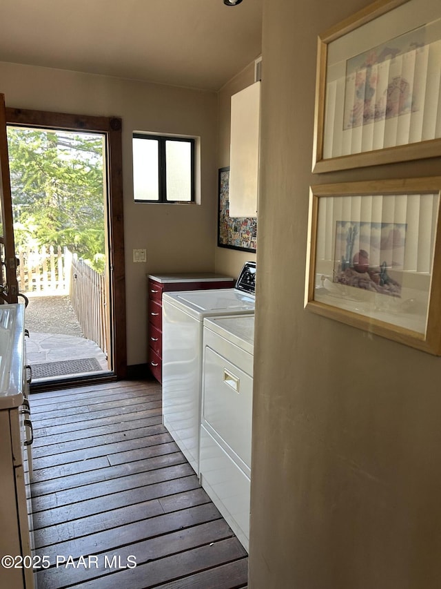 laundry room featuring separate washer and dryer and wood-type flooring