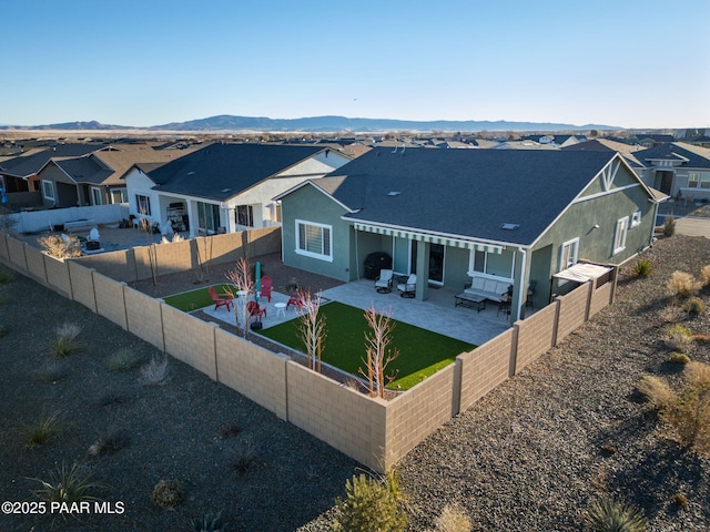 back of property featuring a patio, a mountain view, and outdoor lounge area