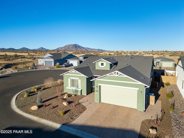 view of front facade featuring a garage and a mountain view