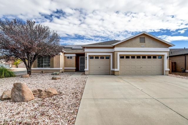 view of front of house featuring solar panels and a garage