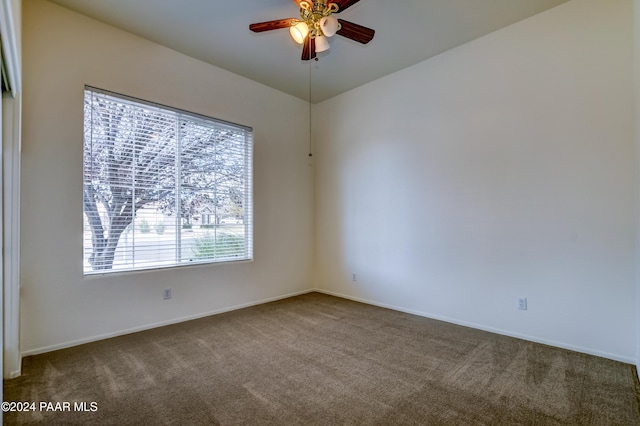 carpeted spare room with ceiling fan