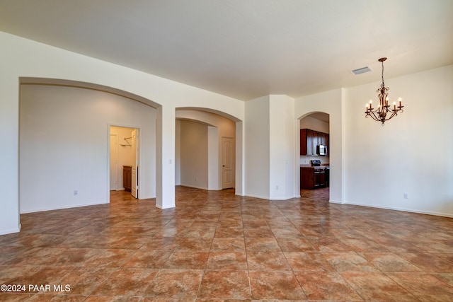 spare room featuring a notable chandelier