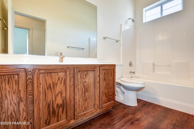 full bathroom featuring hardwood / wood-style flooring, vanity, toilet, and shower / bathing tub combination