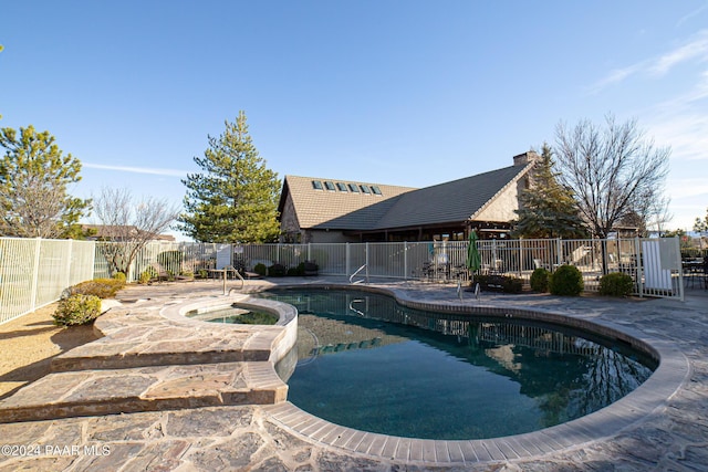 view of pool with an in ground hot tub