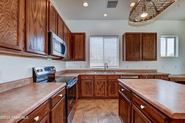 kitchen with light tile patterned flooring, sink, and stainless steel appliances