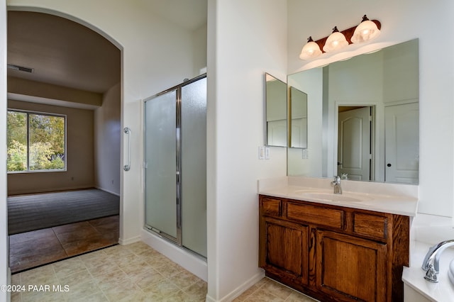 bathroom with tile patterned floors, vanity, and shower with separate bathtub