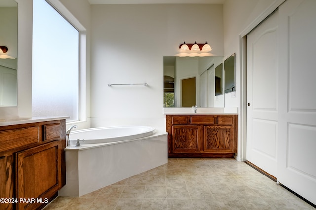 bathroom featuring vanity, tile patterned floors, and a bathtub