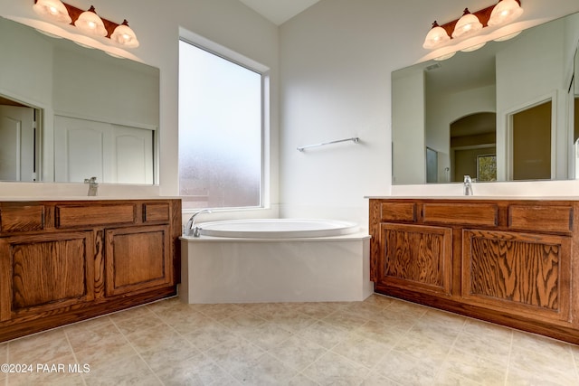 bathroom featuring vanity and a tub