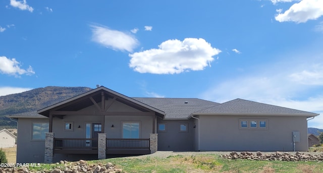 14320 E Casa Serena Way, Prescott Valley, AZ 86315 - view of front of property featuring stucco siding, a mountain view, a shingled roof, and a porch