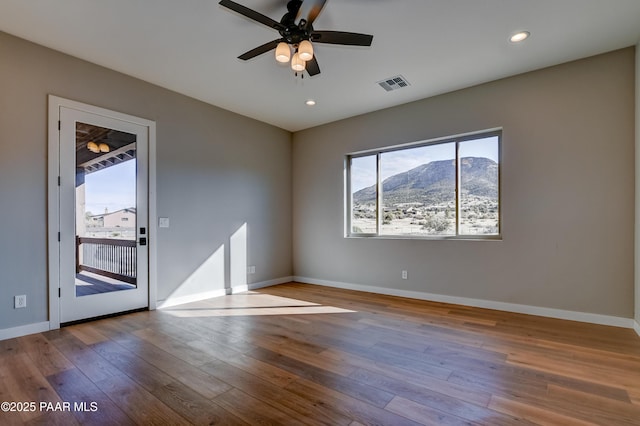 14320 E Casa Serena Way, Prescott Valley, AZ 86315 - spare room featuring hardwood / wood-style flooring, baseboards, a mountain view, a ceiling fan, and recessed lighting