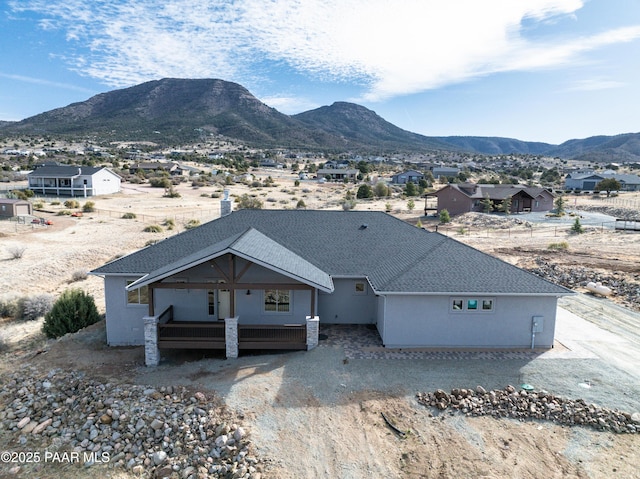 14320 E Casa Serena Way, Prescott Valley, AZ 86315 - view of front facade featuring a mountain view, roof with shingles, and a porch