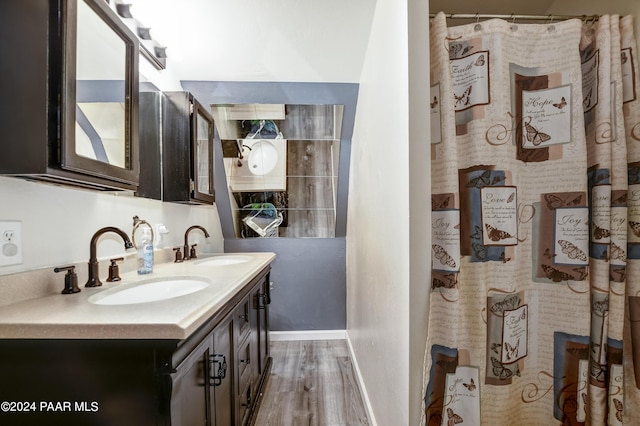 bathroom with wood-type flooring, vanity, and a shower with curtain