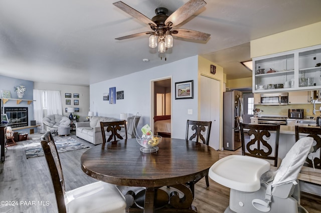 dining space with hardwood / wood-style flooring and ceiling fan