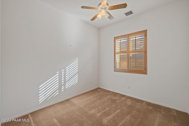 spare room featuring carpet and ceiling fan