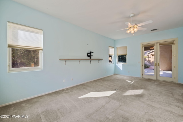 unfurnished room with light colored carpet and ceiling fan