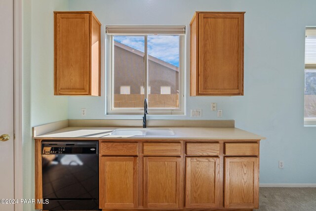 kitchen with light carpet, black dishwasher, and sink