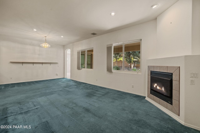 unfurnished living room with a fireplace and carpet flooring