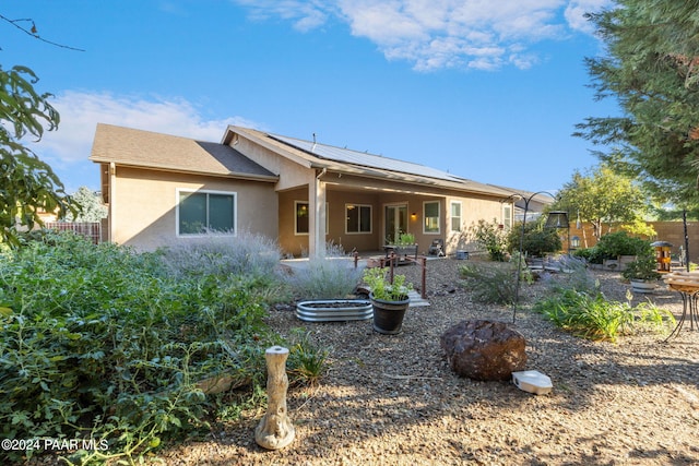 back of house with solar panels