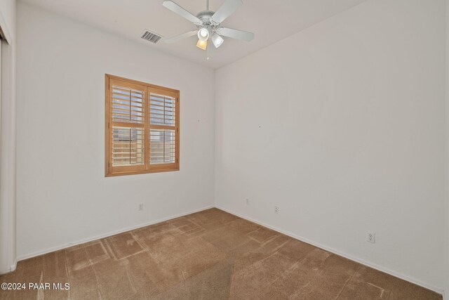 empty room with carpet flooring and ceiling fan