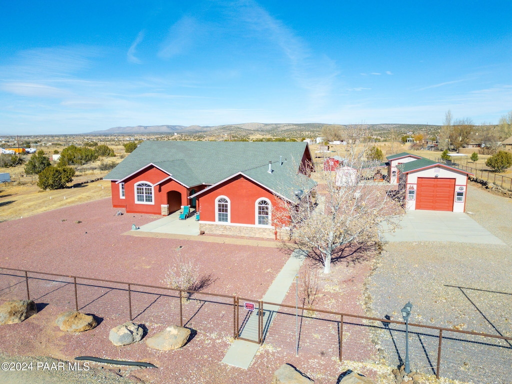 view of front of home with a mountain view, a garage, and an outdoor structure