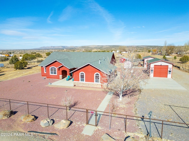 view of front of home with a mountain view, a garage, and an outdoor structure