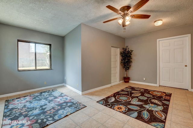 entryway with ceiling fan and a textured ceiling