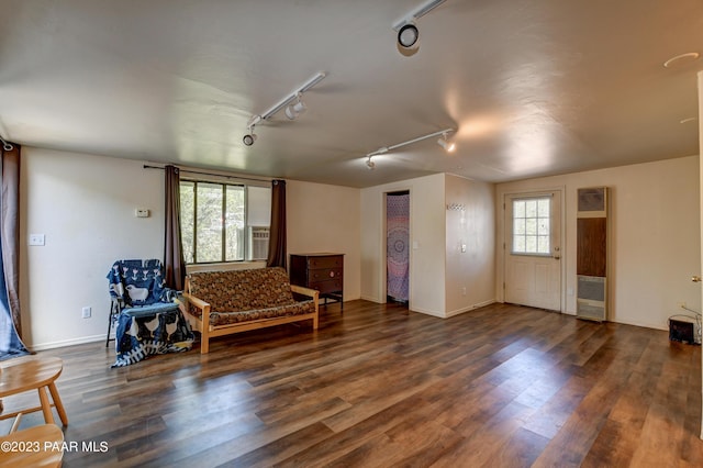 living area with dark wood-type flooring and rail lighting