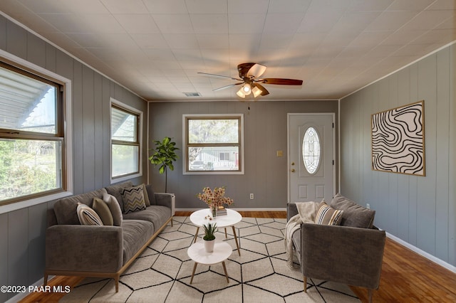 living room with ceiling fan and light hardwood / wood-style flooring