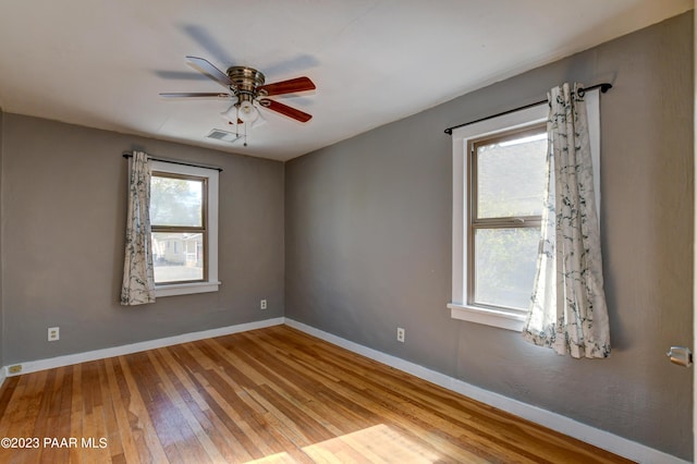 unfurnished room featuring hardwood / wood-style floors and ceiling fan