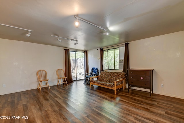 living area with dark wood-type flooring and rail lighting