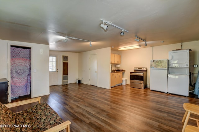 kitchen with stainless steel electric range oven, dark hardwood / wood-style floors, white cabinets, white fridge, and stacked washer / drying machine