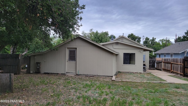 rear view of property with a lawn